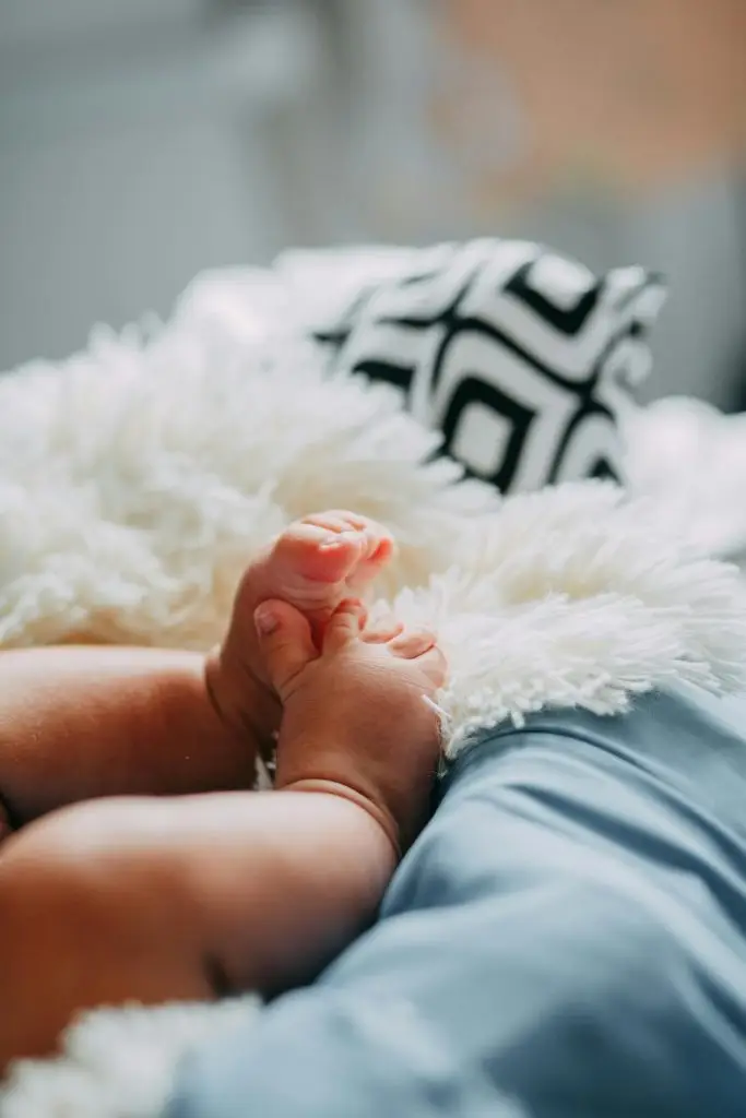Newborn baby feet resting on a soft blanket — symbol of successful surrogacy journey