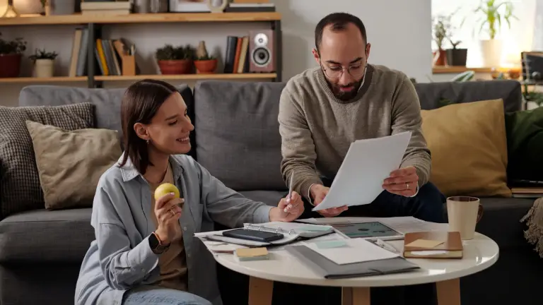 Intended parents reviewing documents while choosing a surrogacy agency and evaluating legal and financial considerations