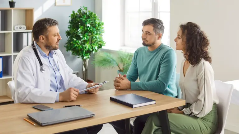 Intended parents speaking with fertility doctor during surrogacy consultation in Los Angeles
