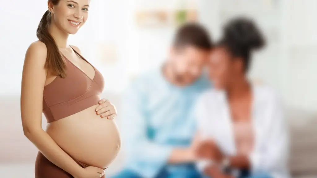 Smiling pregnant surrogate woman standing confidently, with a blurred background showing intended parents admiring their newborn, representing modern surrogacy and family-building journeys in 2025.