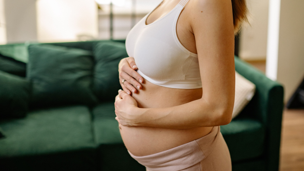 Pregnant woman representing a surrogate profile being reviewed by intended parents