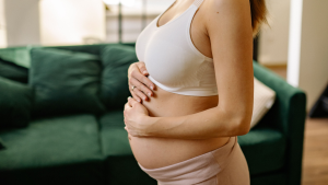 Pregnant woman representing a surrogate profile being reviewed by intended parents
